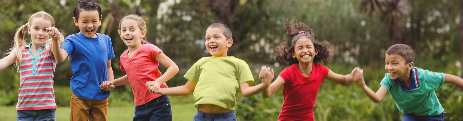 Six children playing outside holding hands