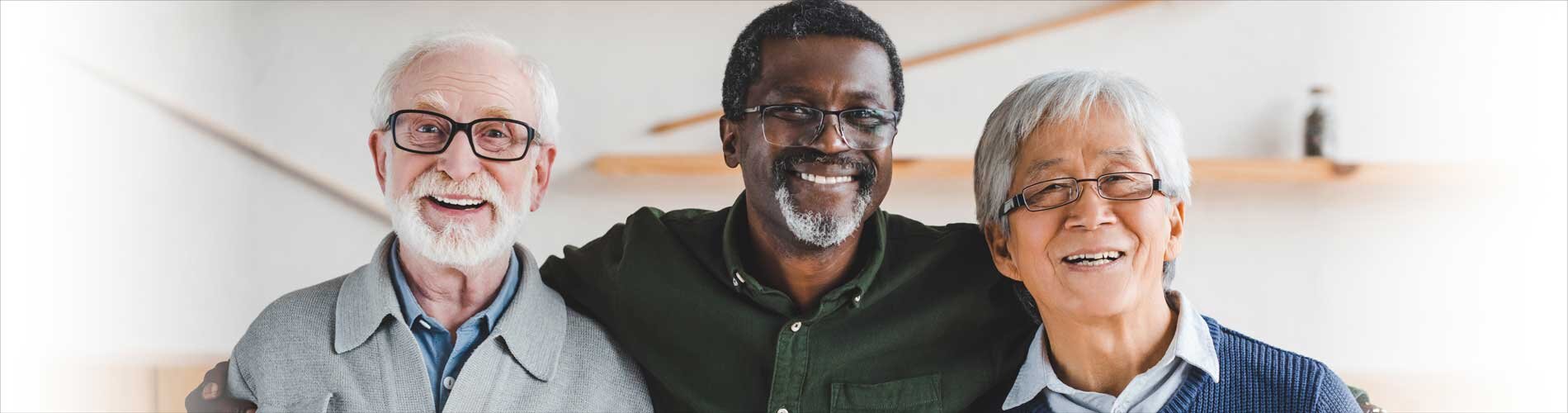 Three diverse elderly people smiling